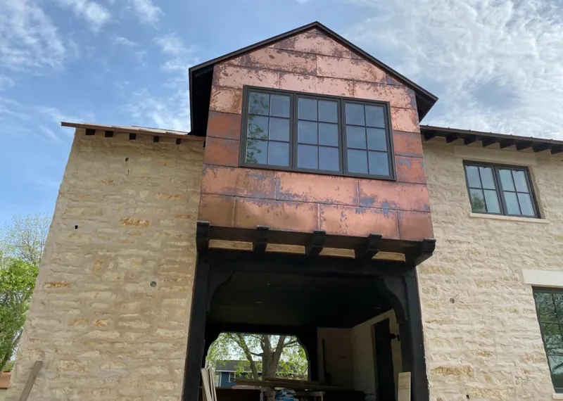 Copper metal panel facade on a stone building for Skylight Installation in Alabaster